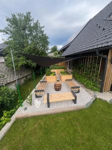 a group of benches sitting in a yard at Castle view Chalet - ZemvaStays in Zgornje Gorje