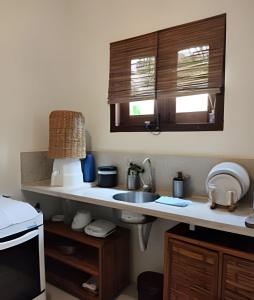 a kitchen with a sink and a counter top at Licuri Praia de Algodões paz amor na beira do mar in Marau