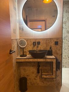a bathroom with a sink and a mirror at Ferienwohnung Am Schlagbaum in Kaltennordheim