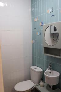 a bathroom with a toilet and a sink and a mirror at Estudio Puerto Isla in Isla Cristina +16 photos