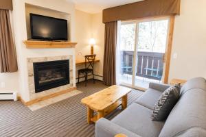 a living room with a couch and a fireplace at Appenzell Inn in Estes Park