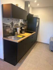 a kitchen with a sink and a counter top at Ferienwohnung Am Schlagbaum in Kaltennordheim
