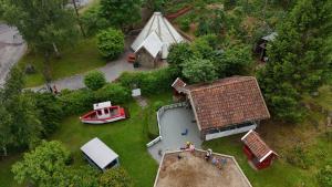 an aerial view of a house with a boat in the yard at Vaicay Garden Resort in Arendal