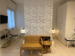 a living room with a chair and a fireplace at Oleander House apartments in Torri del Benaco