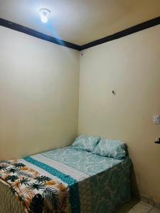 a small bedroom with a bed in the corner at MT Laser casa 2 in São José da Coroa Grande