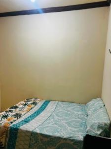 a small bed in a corner of a room at MT Laser casa 2 in São José da Coroa Grande