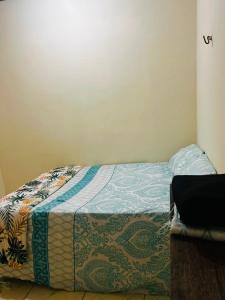 a bed with a quilt on it in a room at MT Laser casa 2 in São José da Coroa Grande +24 photos