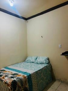 a small bedroom with a bed in the corner at MT Laser casa 2 in São José da Coroa Grande