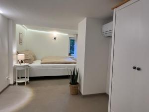a bedroom with a bed in a white room at Ferienhaus an der Eder in Edertal