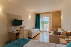 a hotel room with a bed and a living room at Hotel Villa MiraMar in Omiš