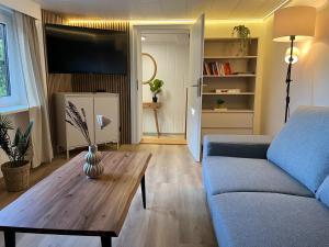 a living room with a couch and a coffee table at Ferienhaus an der Eder in Edertal