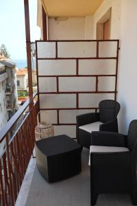 a balcony with chairs and tables on a building at Casa Riviera Chiara con Parcheggio Privato nel Cuore di Arma in Arma di Taggia +20 photos