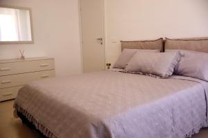 a bedroom with a bed and a dresser in it at Casa Riviera Chiara con Parcheggio Privato nel Cuore di Arma in Arma di Taggia