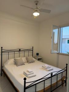 a bedroom with a bed with towels on it at Salento Holiday Home in Torre Inserraglio +28 photos