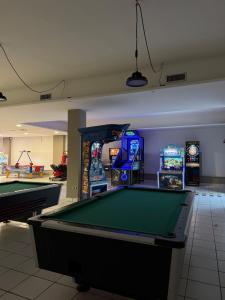 a room with a pool table and arcade games at Salento Holiday Home in Torre Inserraglio