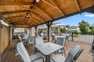 a patio with tables and chairs on a wooden deck at Granby Hotel in Gravesend +28 photos