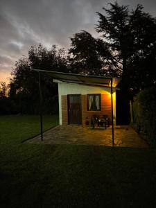 a small house with a patio at night at El rincón in Merlo +2 photos
