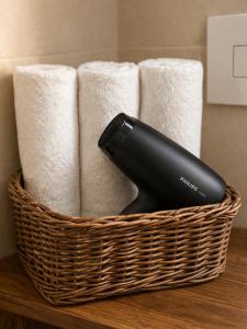a black phone in a basket next to towels at RELAIS TORRE GLORIA in Naples