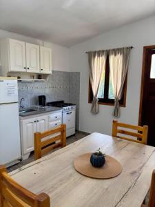 a kitchen with a table with a hat on it at El rincón in Merlo