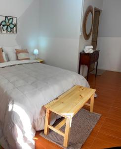 a bedroom with a bed and a wooden table at El rincón in Merlo