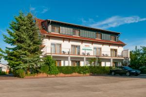 a building with a car parked in front of it at Hotel Bett & Frühstück in Riedstadt