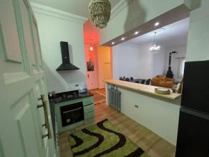 a kitchen with a stove and a counter top at Beit Rifi Mountain Escape, with intex pool, Feitroun in Al ‘Aqabah +4 photos