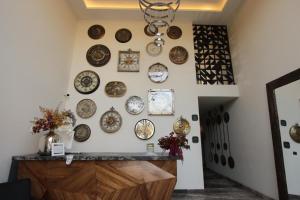 a wall full of plates on a wall at Hotel Alma Boutique in Jiutepec