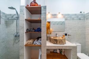 a bathroom with a sink and a shower at Le havre des palmiers in Tsivonoabe +8 photos
