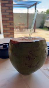 a cup with a straw in it sitting on a table at pousada ilha do amor in Barreirinhas