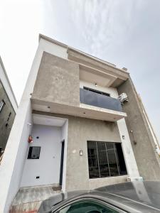 a house with a car parked in front of it at Domina Serviced Apartment in Kubwa