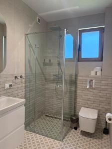 a bathroom with a shower and a toilet and a sink at Port Rewa in Rewa