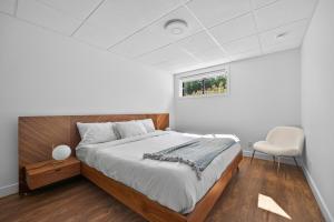 a bedroom with a bed and a window and a chair at Unit 178 - 4 bedrooms - Sleeps 8 in Beaupré