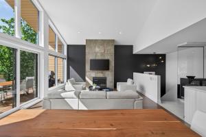 a living room with white furniture and a fireplace at Unit 178 - 4 bedrooms - Sleeps 8 in Beaupré