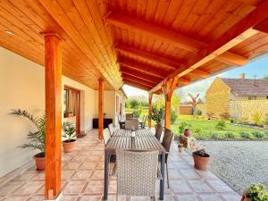 an outdoor patio with a wooden pergola at Lavanda Vendégház in Németkér