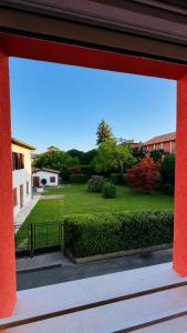 a view of a garden from a window of a building at Venice Easy Stay Meolo in Meolo