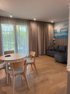 a living room with a table and chairs and a couch at Port Rewa in Rewa