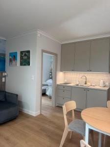 a kitchen and living room with a table and a couch at Port Rewa in Rewa