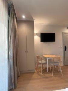 a dining room with a table and chairs and a tv at Port Rewa in Rewa +126 photos