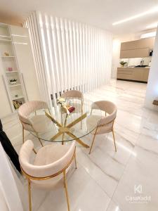 a dining room with a glass table and chairs at CasaKadd Grand Escape in Civé +4 photos