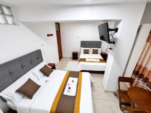 a room with two beds and a television in it at Hotel World Peru in Lima +1 photo