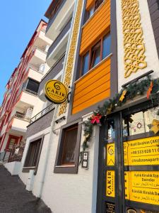 a building with yellow and orange signs on it at Çakır Residence in Trabzon