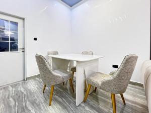 a meeting room with a white table and chairs at Domina Serviced Apartment in Kubwa +4 photos