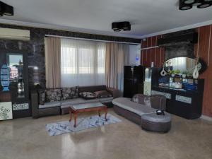 a living room with a couch and a table at Villa Celia -New Cairo in Cairo