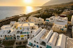 an aerial view of a city with the ocean at Delor Studio Drymades,Santorini in Dhërmi