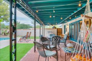 a patio with chairs and a table at Private Tucson Oasis with Pool & Large Backyard in Tucson