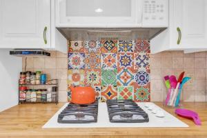 a kitchen with a stove with an orange pot on it at Private Tucson Oasis with Pool & Large Backyard in Tucson