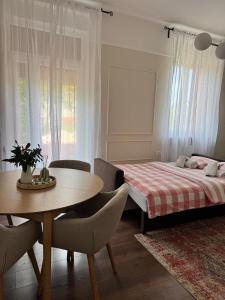 a bedroom with a bed and a table and chairs at Little Paradise - charming apartment in Labin