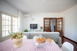 a living room with a table and a couch at Casa da Cesta in Celorico de Basto
