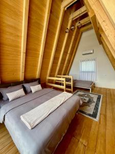 a large bed in a room with wooden walls at Villa Kovacevic 2 in Bihać +35 photos