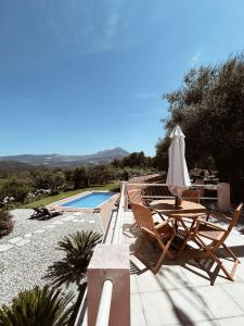a patio with a table and chairs and a pool at Casa da Cesta in Celorico de Basto